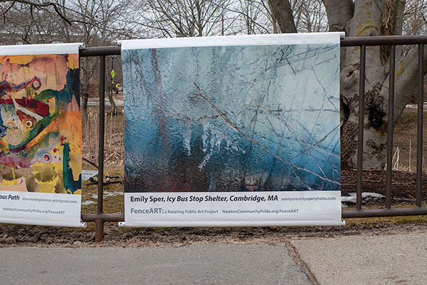 photo of banner with photo of ice on fence